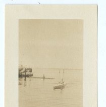 02.11 Two people kayaking, dock in background